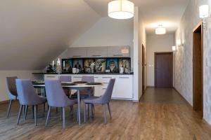 a kitchen with a dining room table and chairs at Złota Jesień Restauracja i Noclegi nad jeziorem in Kartuzy