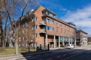 a large red brick building on a city street at Comfort Hotel Park in Trondheim