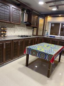 a kitchen with a table in the middle of it at شقة مفروشة للايجار in Irbid