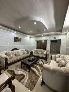 a large living room with couches and a table at شقة مفروشة للايجار in Irbid