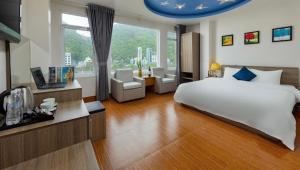 a bedroom with a large bed and a large window at Catba Central Hotel 2 in Cat Ba