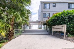 a building with stairs and a bench in front of it at The Poplars, 15,36 Magnus Street - Unit in a great complex with a pool and close to town in Nelson Bay