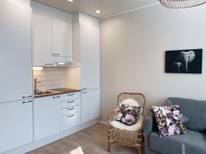 a living room with a couch and a kitchen at Männikkö in Kalajoki
