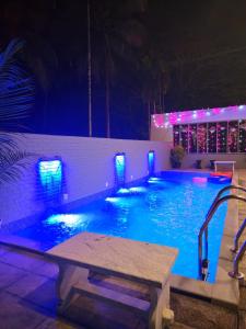 a swimming pool at night with blue lights in it at Clive Ten Resorts Athirappilly in Kizhake Chālakudi