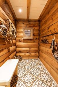 a sauna with wooden walls and a tile floor at Luxurious and modern log cabin close to nature in Lislevatn