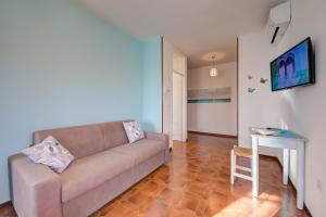 een woonkamer met een bank en een tafel bij Villa Fiorita Apartments - Happy Rentals in Sirmione