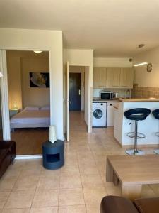 a room with a kitchen and a living room at Superbe 2P proche plages - Piscine in Juan-les-Pins