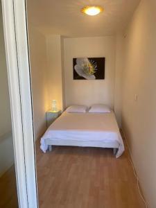 a bedroom with a bed with a flower on the wall at Superbe 2P proche plages - Piscine in Juan-les-Pins