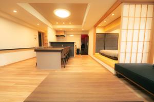 a room with a table and chairs and a bed at MolinHotels702 アクティビティを満喫できる札幌定山渓 天然温泉付-1L2Room K-Bed1&W-beds3 8persons in Jozankei