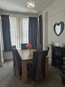 a dining room with a wooden table and chairs at Central Luxury Town House in Blackpool