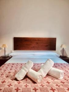 a bed with two rolled up towels on it at Central, near the Alhambra, quiet and autentic! in Granada