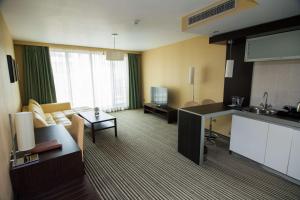 a hotel room with a kitchen and a living room at Best Western Plus Olives City Hotel - Free Parking in Sofia