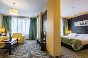 a hotel room with a bed and a chair at Best Western Plus Olives City Hotel - Free Parking in Sofia