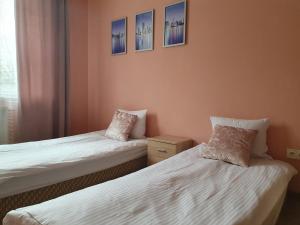 two beds in a room with two pillows at Luna in Wrocław