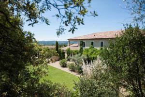 a house with a garden in front of it at Bastide dou Pastre Family friendly house with amazing view in Mérindol