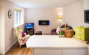 ein Wohnzimmer mit einer weißen Theke und einem Wohnzimmer in der Unterkunft The Retreat, own hot tub, romantic escape, near Lyme Regis in Lyme Regis