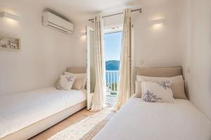 Ένα ή περισσότερα κρεβάτια σε δωμάτιο στο Villa Island Grande in Mykonos