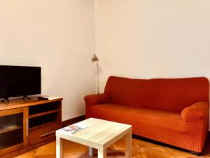a living room with a couch and a coffee table at Central, near the Alhambra, quiet and autentic! in Granada