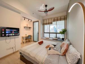 a bedroom with a bed and a flat screen tv at The Luxe KLCC View Sky Pool in Kuala Lumpur