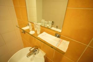 a bathroom with a sink and a mirror at Citrus Hotel Johor Bahru by Compass Hospitality in Johor Bahru