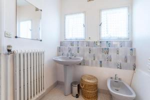 a bathroom with a sink and a toilet and a mirror at Grande maison familiale in Douarnenez +26 photos