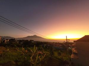 a sunset over a city with a mountain in the background at Cordoba residence F5 in Tlekung