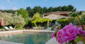 a villa with a swimming pool and a house at Bastide dou Pastre Family friendly house with amazing view in Mérindol
