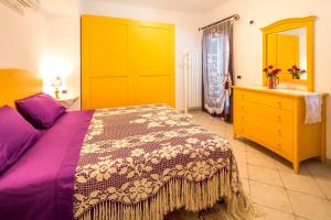 a bedroom with a bed and a dresser and a sink at Borgo dell'Uccellaia - Ambra in Marciana Marina