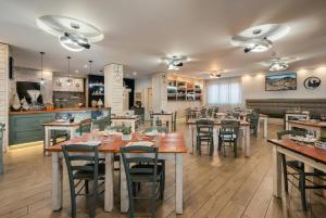 a restaurant with tables and chairs in a room at Hotel La Fenice in Castel di Sangro