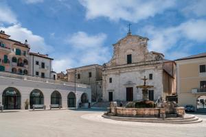 an old building with a fountain in a courtyard at Hotel La Fenice in Castel di Sangro