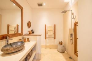 a bathroom with a large rock sink on a counter at Exquisite 4br Haven, 5min Stroll To Beach Canggu in Canggu