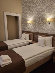 Posteľ alebo postele v izbe v ubytovaní Hotel Maximum