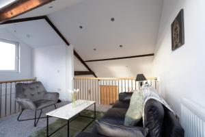 ein Wohnzimmer mit einem Sofa, einem Tisch und Stühlen in der Unterkunft June Disc - Long Stay - Contractors in Cardiff