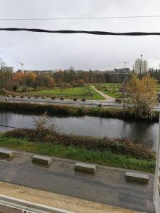 a view of a river with a road and a street at Jungle Chic au bord du Canal Saint-Martin in Rennes