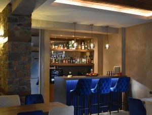 a bar with blue chairs in a restaurant at Ζέον Ύδωρ in Orma
