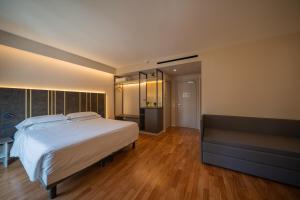 En eller flere senger på et rom på Plaza Hotel Catania