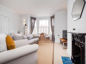 a living room with a couch and a table at The Sands Sheringham in Sheringham