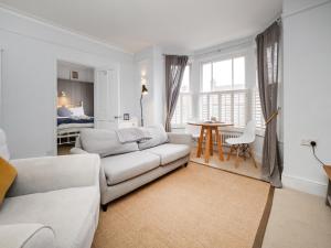 a living room with a couch and a table at The Sands Sheringham in Sheringham
