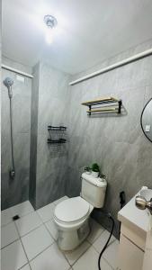 a bathroom with a toilet and a shower at ECO Staycation - En Casa Orila in Manila