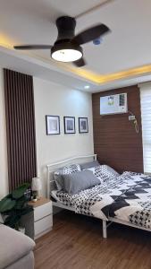 a bedroom with a bed and a ceiling fan at ECO Staycation - En Casa Orila in Manila
