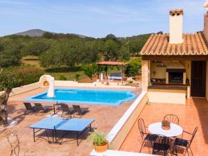 eine Terrasse mit Tischen und Stühlen sowie einem Pool in der Unterkunft Sa caseta in Artá