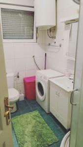 a bathroom with a washing machine and a sink at Apartment Boulevard in Belgrade