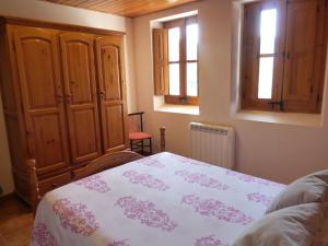 ein Schlafzimmer mit einem Bett und zwei Fenstern in der Unterkunft Luxurious Cottage in Sant Salvador de Guardiola in Guardiola