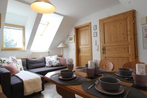 a living room with a couch and a table at Landhaus Nockalm in Bad Kleinkirchheim