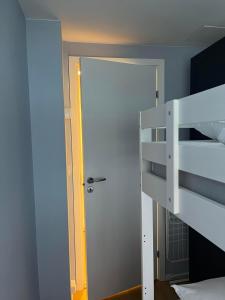 a bedroom with a bunk bed and a open door at Dokkeveien Apartment in Bergen