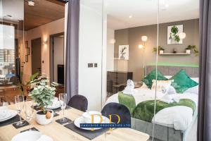 a room with a bed and a table with a dining room at The Executive Suite - By Parydise Properties - Business or Leisure stays - Sleeps 2 - Deansgate, Manchester in Manchester