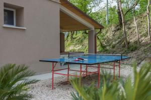 a ping pong table in front of a house at Villa Gea 12 in Fermignano