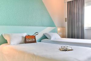 Postel nebo postele na pokoji v ubytování ibis budget Tours Sud