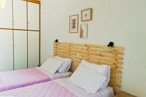 two beds sitting next to each other in a bedroom at Kapougiati Studios in Ilia