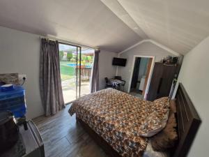 a bedroom with a bed and a large window at Vosloo's rest in Vereeniging